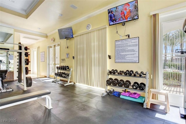 gym featuring baseboards and ornamental molding