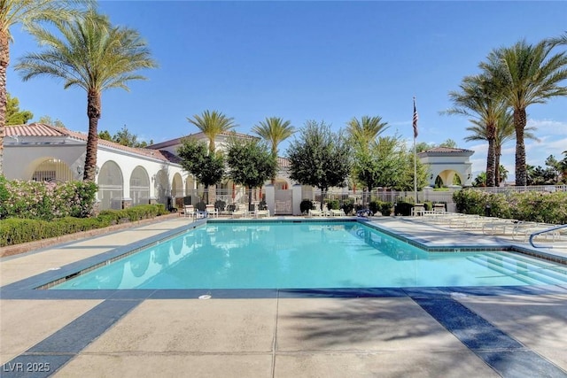 pool featuring a patio area and fence