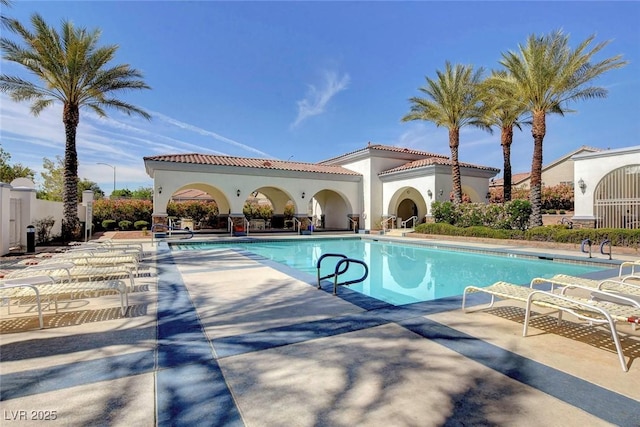 pool featuring a patio area and fence