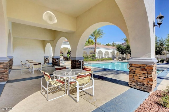 view of patio / terrace with outdoor dining area and a community pool