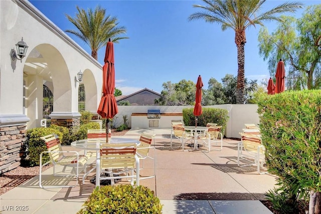 view of patio / terrace featuring grilling area, an outdoor kitchen, and outdoor dining area