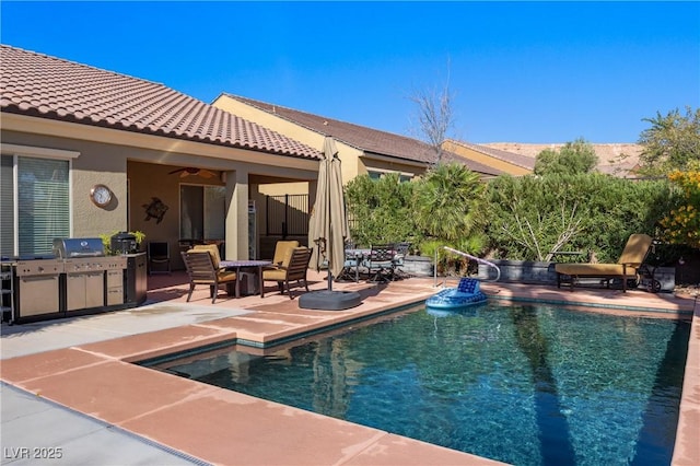 view of swimming pool featuring a patio area, area for grilling, a fenced in pool, and a ceiling fan