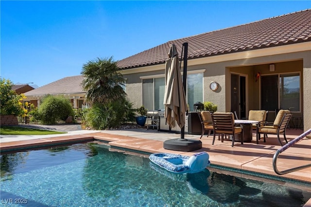 outdoor pool with a patio area