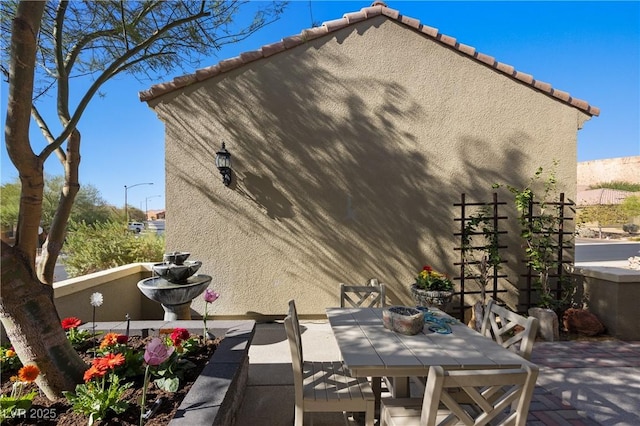 exterior space with outdoor dining space and fence