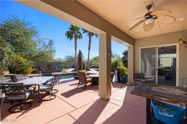 view of patio with a ceiling fan, outdoor dining area, a fenced backyard, and a fenced in pool