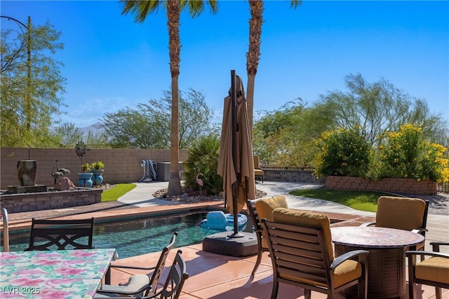 view of swimming pool with a patio area, a fenced in pool, and a fenced backyard