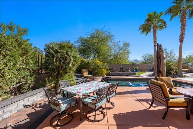 view of patio / terrace with outdoor dining area, a fenced in pool, and a fenced backyard