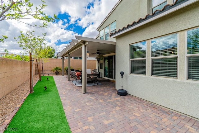 view of patio with a fenced backyard and ceiling fan