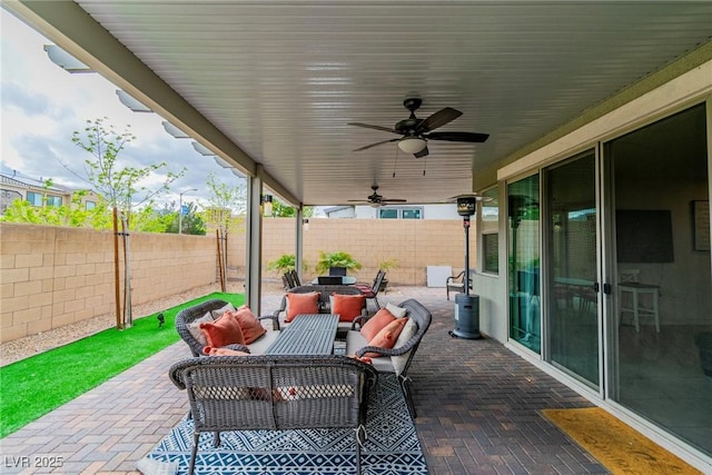 view of patio with ceiling fan, a fenced backyard, and outdoor lounge area