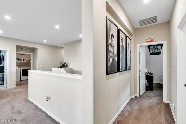 hallway featuring visible vents, independent washer and dryer, recessed lighting, carpet floors, and baseboards