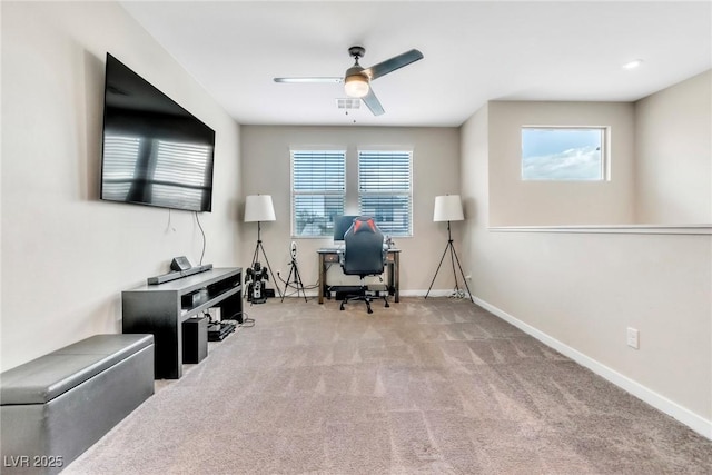 office featuring a wealth of natural light, visible vents, carpet, and ceiling fan