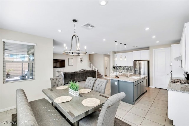 dining area featuring light tile patterned floors, visible vents, recessed lighting, and stairs