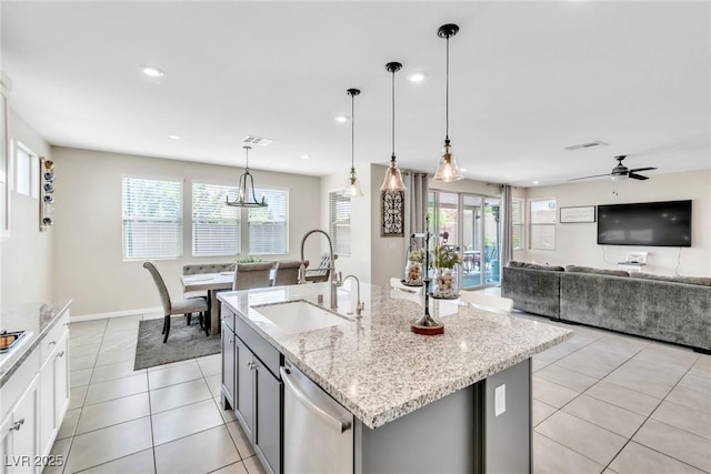 kitchen featuring a healthy amount of sunlight, visible vents, light tile patterned flooring, a sink, and dishwasher