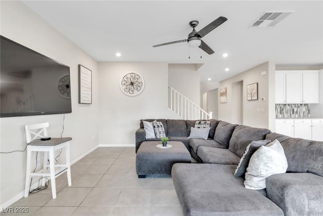 living room with light tile patterned floors, a ceiling fan, visible vents, recessed lighting, and stairs