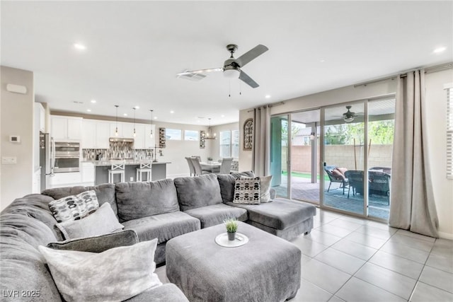 living room with light tile patterned floors, recessed lighting, visible vents, and ceiling fan