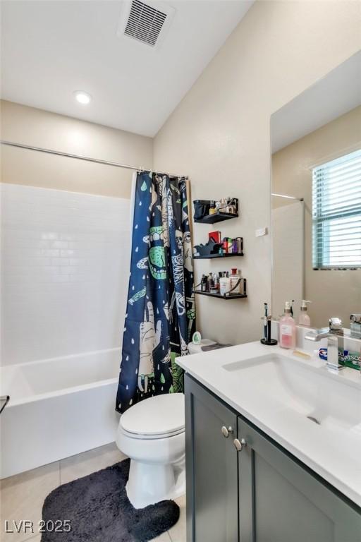 full bathroom with vanity, shower / bathtub combination with curtain, visible vents, tile patterned floors, and toilet