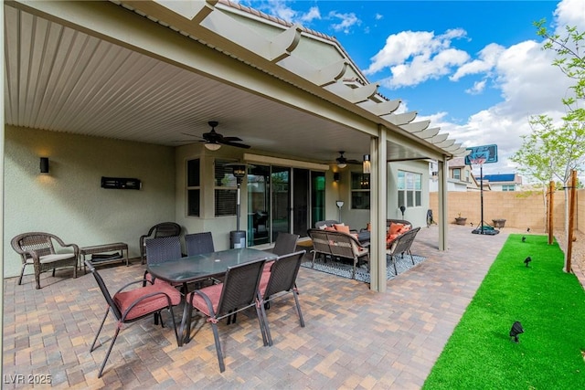 view of patio / terrace with outdoor dining area, an outdoor hangout area, a fenced backyard, and a ceiling fan