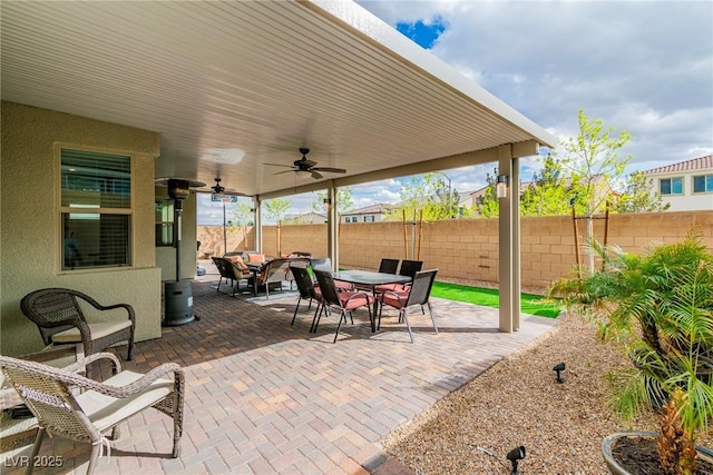 view of patio / terrace featuring outdoor dining area, a ceiling fan, and fence