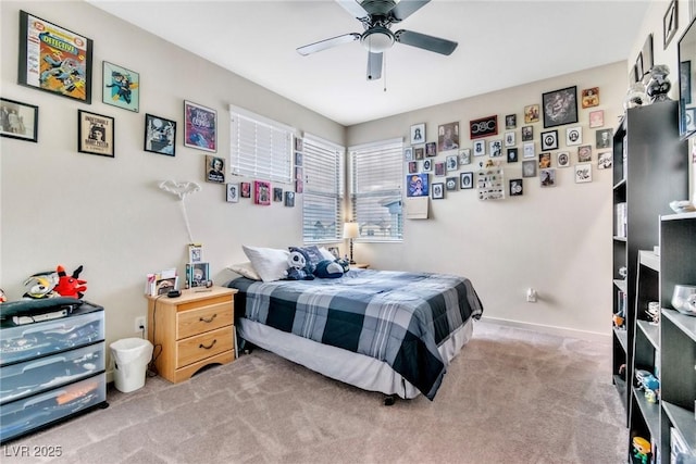 carpeted bedroom with baseboards and a ceiling fan