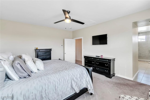 bedroom with visible vents, light carpet, connected bathroom, baseboards, and ceiling fan