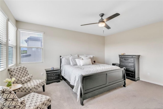 bedroom with light carpet and ceiling fan