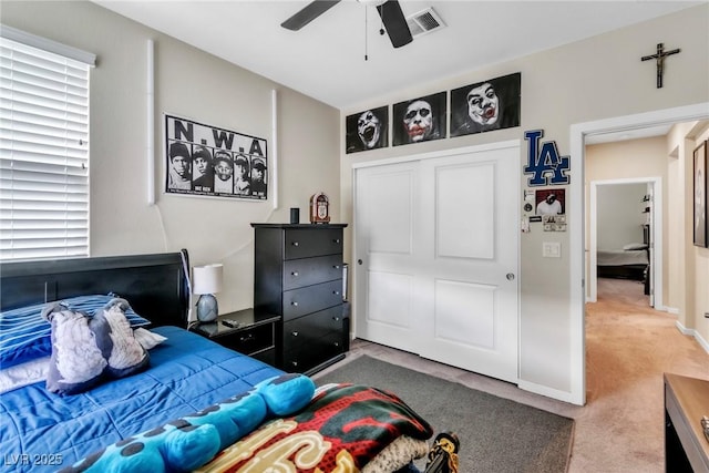 bedroom with visible vents, a closet, carpet, baseboards, and ceiling fan