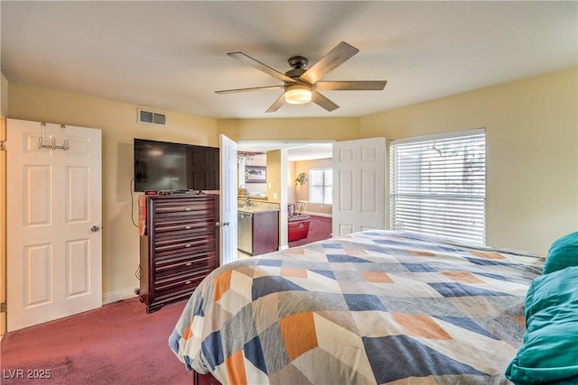 carpeted bedroom with a ceiling fan and visible vents