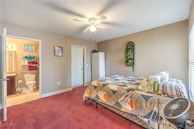 bedroom featuring ceiling fan, connected bathroom, baseboards, and light carpet