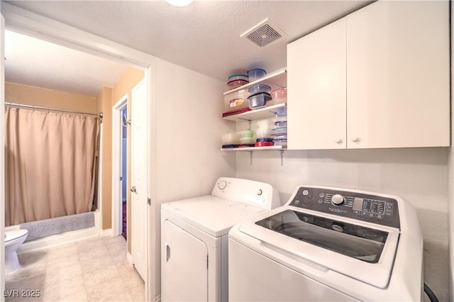 laundry area featuring washer and clothes dryer and visible vents