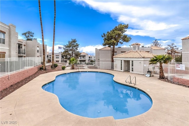 pool with a residential view, a patio, and fence