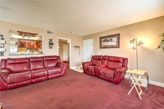 carpeted living area with baseboards and visible vents