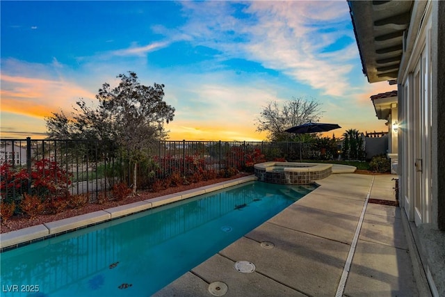 view of swimming pool featuring a patio, a fenced backyard, and a pool with connected hot tub