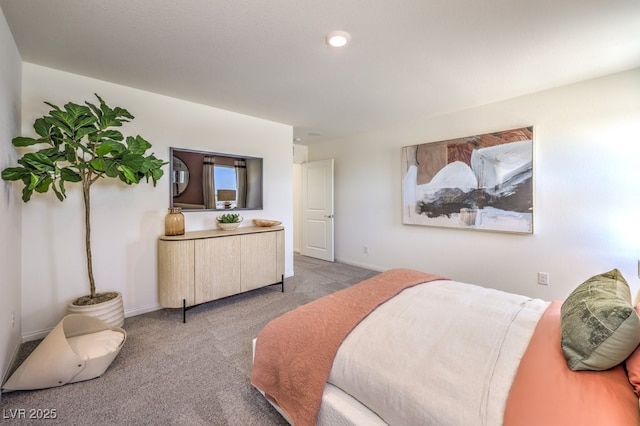 bedroom with light colored carpet and baseboards