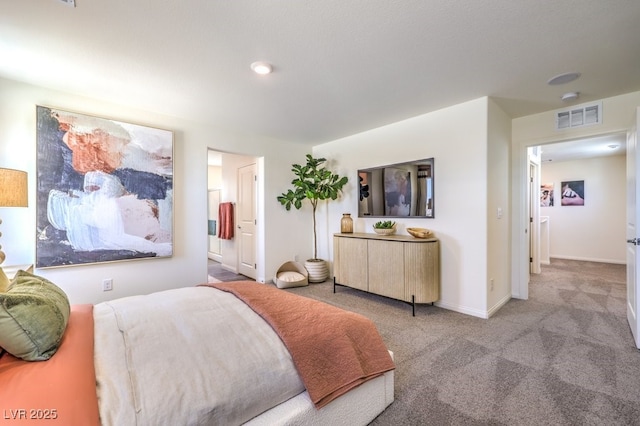 bedroom with ensuite bath, visible vents, baseboards, and carpet