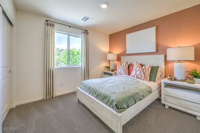 bedroom featuring visible vents, baseboards, and carpet