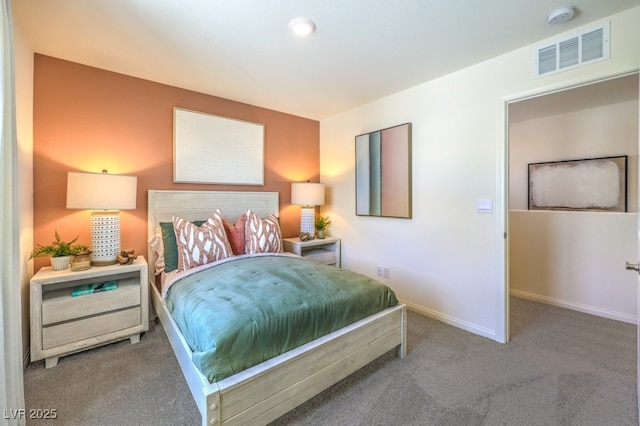 carpeted bedroom with visible vents and baseboards