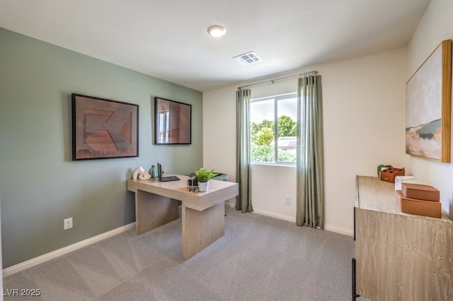 office space featuring visible vents, light carpet, and baseboards