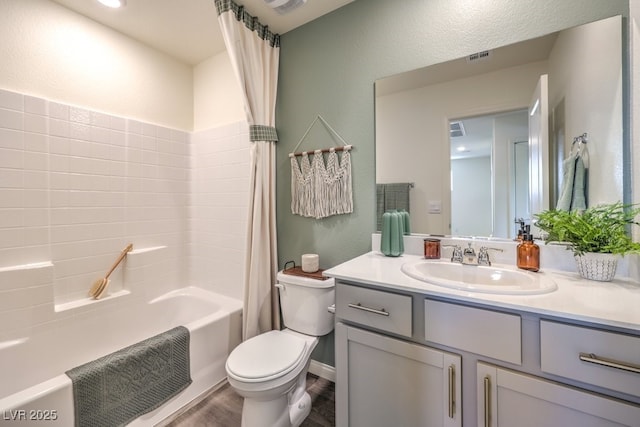 bathroom with visible vents, toilet, shower / tub combo with curtain, and vanity