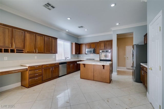 kitchen featuring light countertops, visible vents, appliances with stainless steel finishes, and a center island