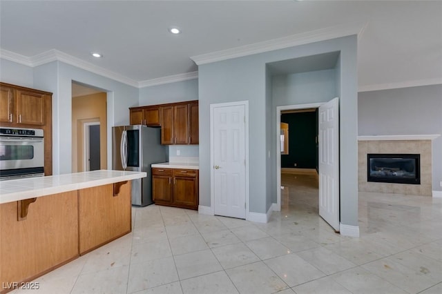 kitchen featuring a breakfast bar, tile countertops, brown cabinetry, and smart refrigerator