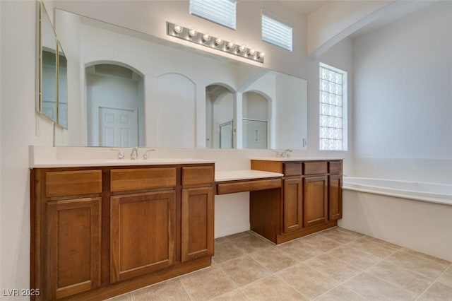 full bathroom featuring vanity, tile patterned floors, and a bath