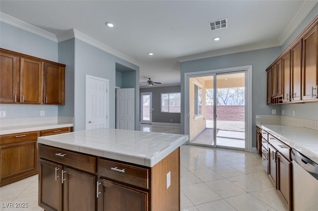 kitchen featuring light tile patterned floors, visible vents, white dishwasher, and crown molding