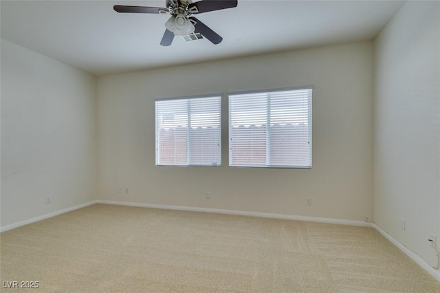 empty room with visible vents, ceiling fan, baseboards, and carpet