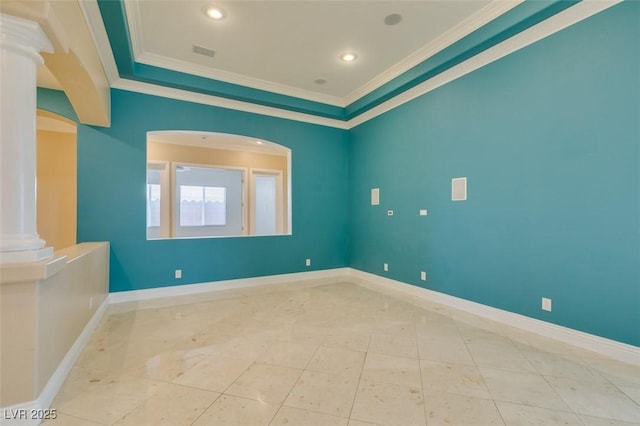 spare room featuring crown molding, decorative columns, baseboards, and a raised ceiling