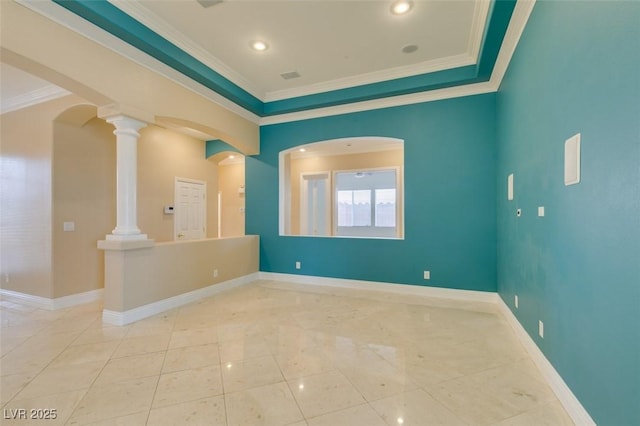 spare room featuring ornate columns, baseboards, and ornamental molding