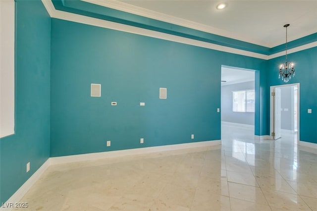 empty room with an inviting chandelier, crown molding, and baseboards