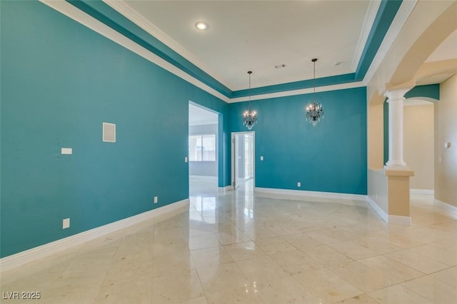 empty room with visible vents, crown molding, baseboards, decorative columns, and an inviting chandelier