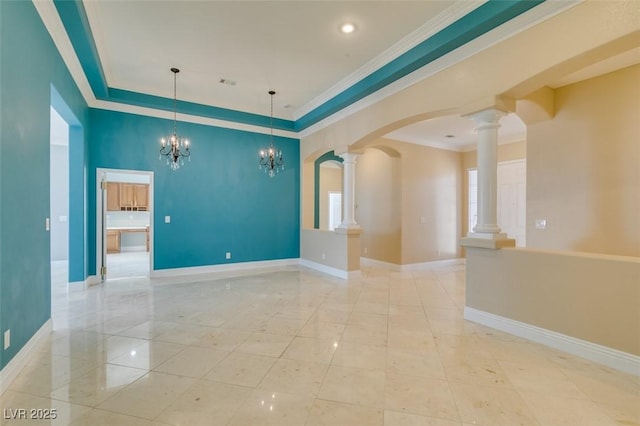 spare room featuring crown molding, baseboards, ornate columns, and a chandelier