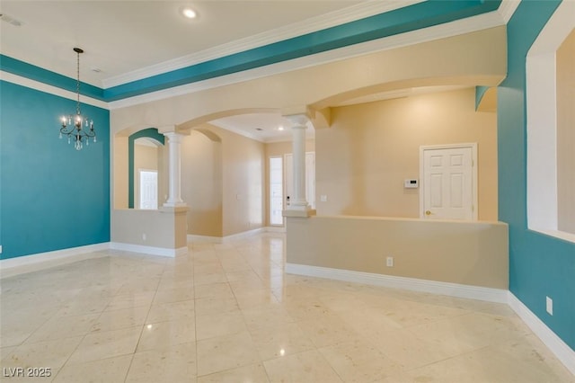 unfurnished room featuring a notable chandelier, baseboards, crown molding, and ornate columns