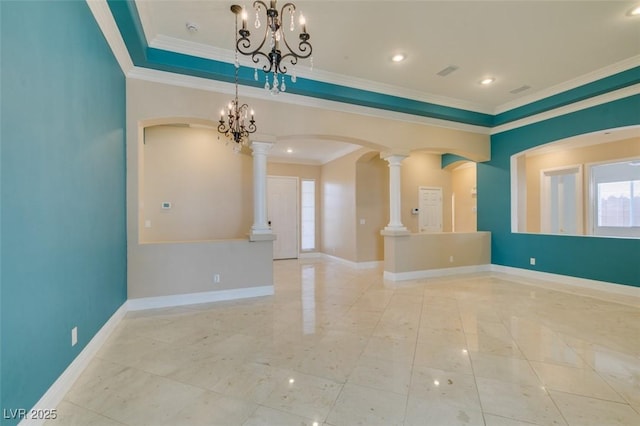 spare room featuring visible vents, baseboards, a chandelier, ornamental molding, and arched walkways